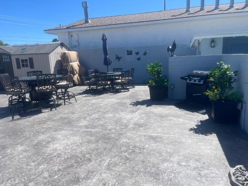 a patio with tables and chairs next to a building at El Rancho Motel in Williams