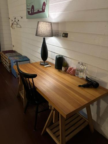 a wooden table with a lamp on top of it at La Locanda in Bangkok