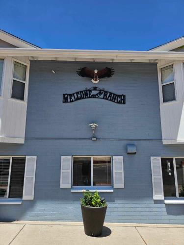 a blue building with a sign on the side of it at El Rancho Motel in Williams