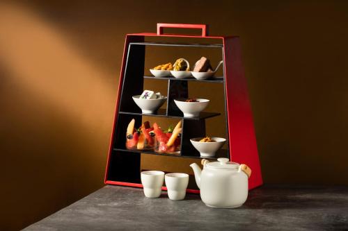 a display case with dishes and cups on a table at Four Points by Sheraton Chengdu, High-Tech Zone Exhibition Center in Chengdu