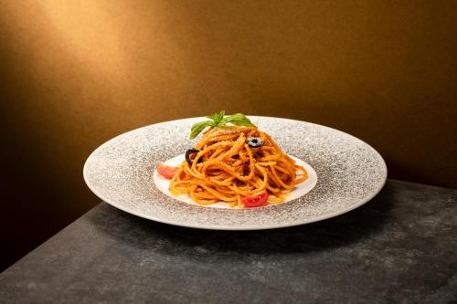 a plate of pasta on top of a table at Four Points by Sheraton Chengdu, High-Tech Zone Exhibition Center in Chengdu