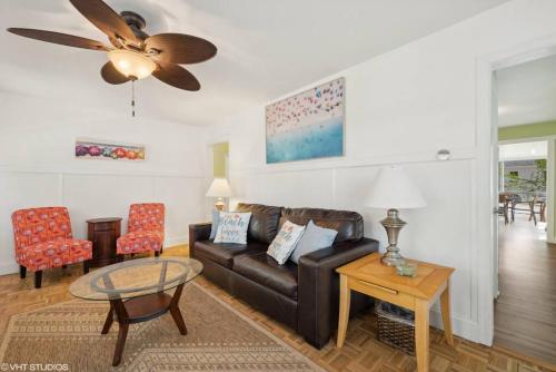 a living room with a couch and a table at Beachside Bliss, Steps to Beach in Michigan City