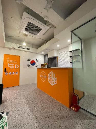 an office with an orange counter and a glass wall at Seoul Cube Myeongdong in Seoul