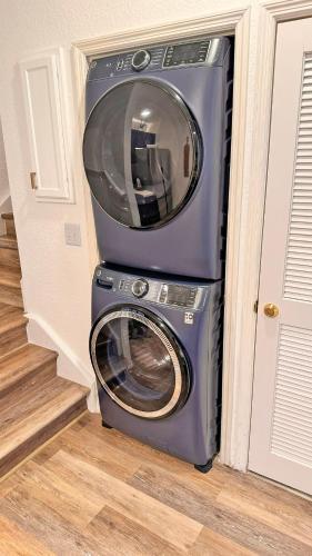 a washer and dryer sitting in a room at Villas at Seven Dwarfs Resort - Near to Disney in Kissimmee