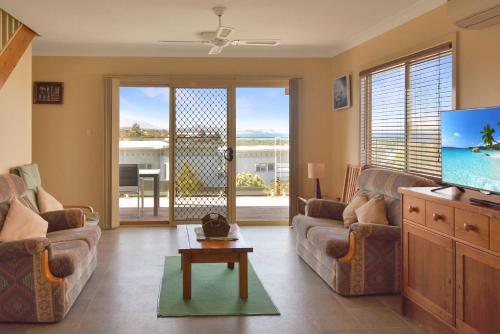 a living room with two couches and a tv at 81 Murrah in Bermagui