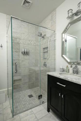 a bathroom with a glass shower and a sink at The Beachfront Estate, 360 Ocean Views, 5700 sqft in Mattapoisett