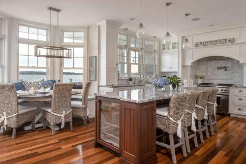 a kitchen and dining room with a table and chairs at The Beachfront Estate, 360 Ocean Views, 5700 sqft in Mattapoisett