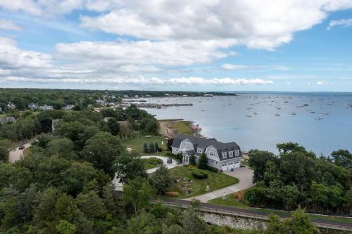 an aerial view of a house on an island in the water at The Beachfront Estate, 360 Ocean Views, 5700 sqft in Mattapoisett