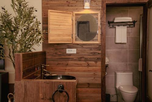 a bathroom with a sink and a toilet at Yangshuo Shui Mo Ju courtyard in Yangshuo