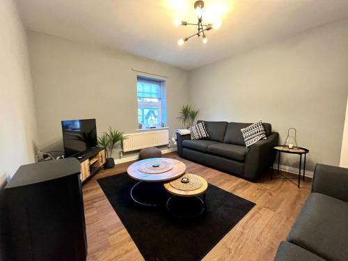 a living room with a couch and a table at Beautiful 3 bedroom home in the heart of Alnwick in Alnwick