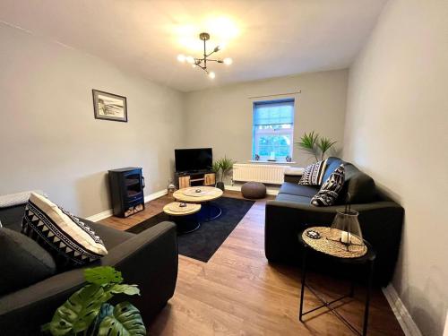 a living room with two couches and a tv at Beautiful 3 bedroom home in the heart of Alnwick in Alnwick