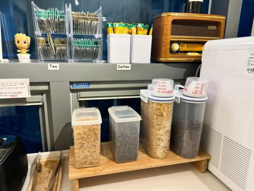 a shelf with four containers of food in a kitchen at Seoul Cube Myeongdong in Seoul