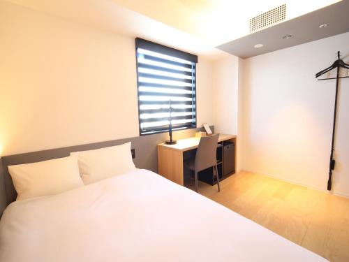 Postel nebo postele na pokoji v ubytování hotel androoms Nagoya Sakae