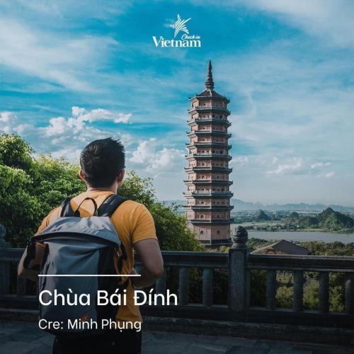 a man with a backpack looking at a chinese building at Cherry homestay in Ninh Binh