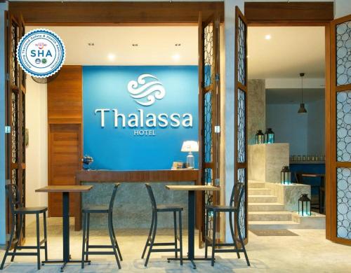 a restaurant with a sign that reads thiasiasosa at Thalassa Hotel in Koh Tao