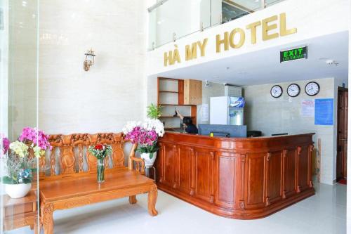 a hotel lobby with a bench and flowers at Ha My Hotel in Ho Chi Minh City