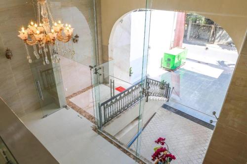 a glass staircase in a building with a chandelier at Ha My Hotel in Ho Chi Minh City