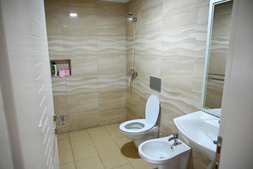 a bathroom with a toilet and a sink at Joni Restaurant in Pogradec
