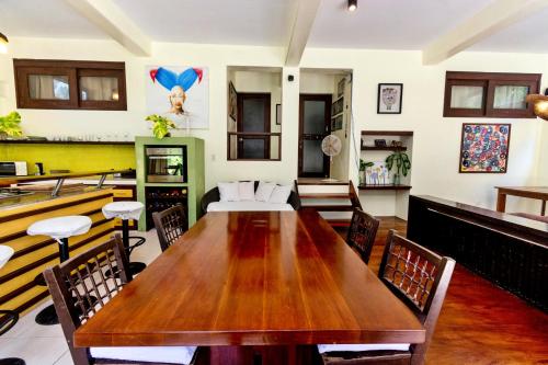 a dining room with a wooden table and chairs at Babosam Apartments in Boracay