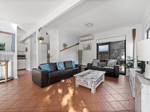 a living room with couches and a coffee table at Riverside Margaret River in Margaret River Town