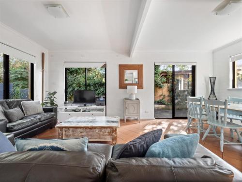 a living room with a couch and a table at Riverside Margaret River in Margaret River Town