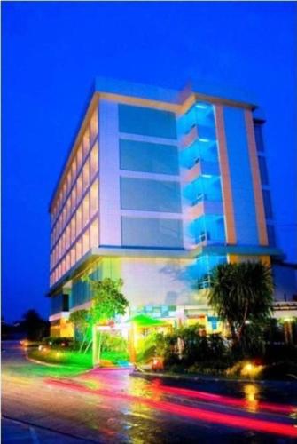 a tall building with a street in front of it at V-One Hotel Korat in Nakhon Ratchasima