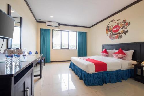 a hotel room with a bed and a kitchen at OYO 329 Hotel Darma Nusantara 2 in Manda