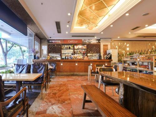 a restaurant with tables and chairs and a bar at New Pearl River Hotel in Guangzhou