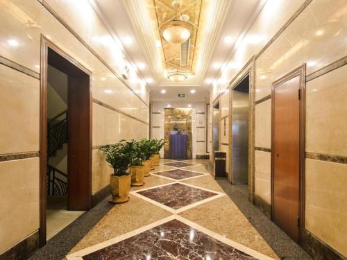 a hallway with potted plants and a ceiling at New Pearl River Hotel in Guangzhou