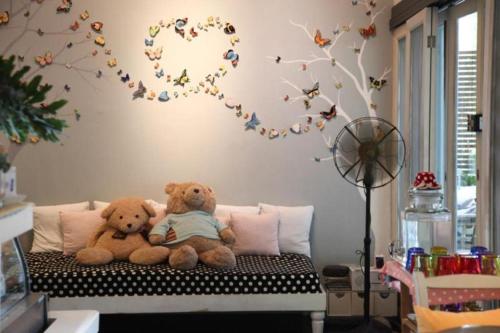 two teddy bears sitting on a bed in a room at Baan Hmon-Oon in Chiang Mai