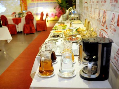 a long table with glasses of food on it at Duy Anh Hotel in Hải Dương