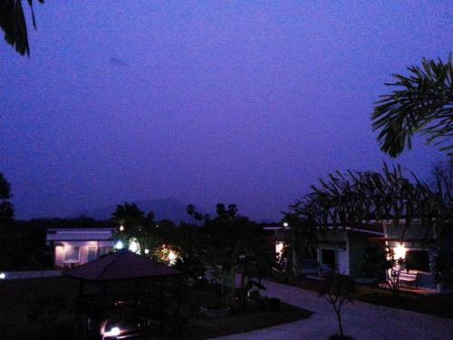 a night time view of a house with lights at BanRai ChernMa Resort in Tak