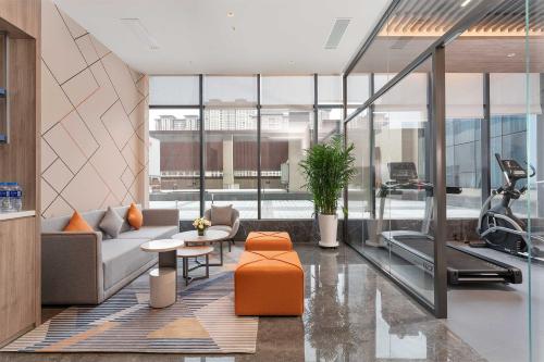 a living room with a couch and a gym at Holiday Inn Express Xi'an Daxing by IHG in Xi'an