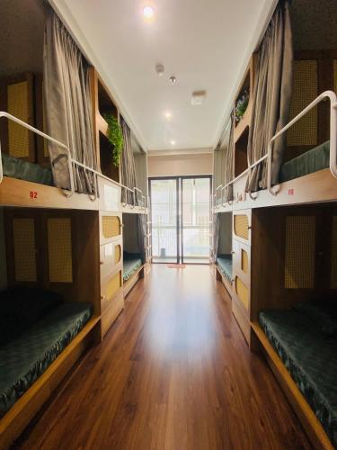 a room with multiple bunk beds with a wooden floor at Hồng Vân Homestay in Cao Bằng