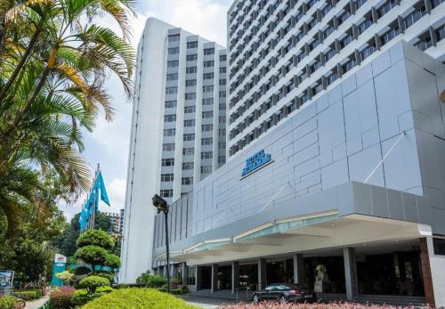 a large building with a car parked in front of it at Hotel Miramar Singapore in Singapore