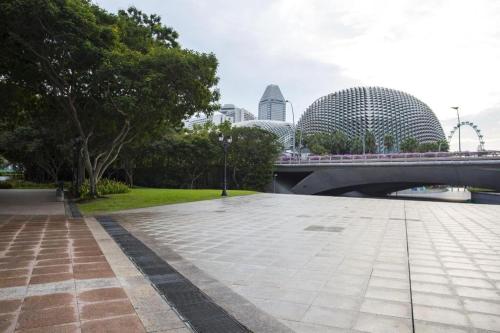 a bridge over a river with buildings in the background at Hotel Miramar Singapore in Singapore