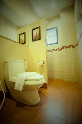 a bathroom with a toilet and a shower at Maytara Hotel in Pattaya South