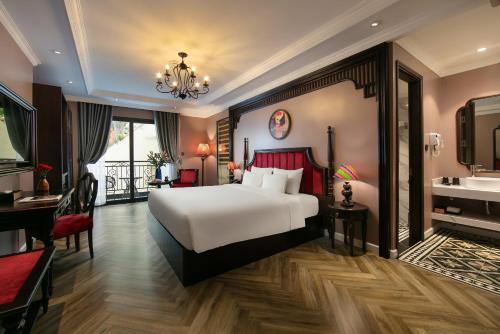 a hotel room with a bed and a sink at Acoustic Premium Hotel & Spa in Hanoi