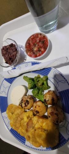 a plate of food with potatoes and sauce on a table at Hostal Xilotl in San José del Sur