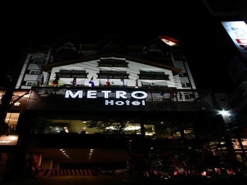 a metro hotel at night with people on the balcony at Metro Tourist Hotel Cheonan in Cheonan