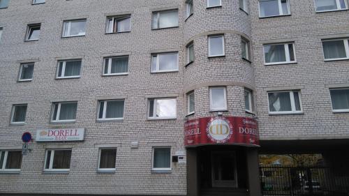 a brick building with a red sign in front of it at Dorell in Tallinn
