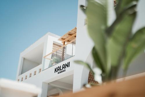a white building with a sign that reads kulum palace at Kalani Residence in Keramotí