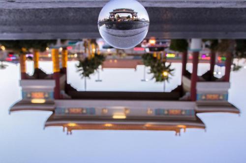 a reflection of a building in a disco ball at Luxury Suites International by Vdara in Las Vegas