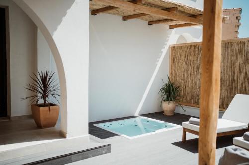 a house with a pool in the middle of a room at Kalani Residence in Keramotí