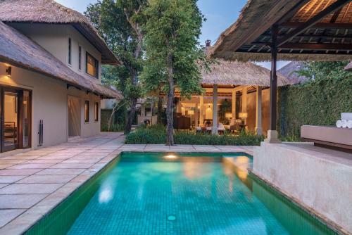 a swimming pool in the backyard of a villa at Kayumanis Sanur Private Villa and Spa in Sanur