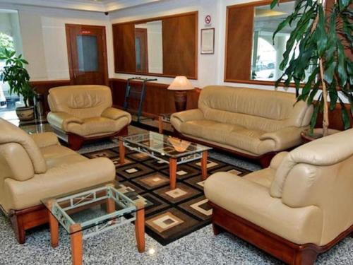 a living room with couches and chairs and a table at Traders Inn Brunei in Bandar Seri Begawan
