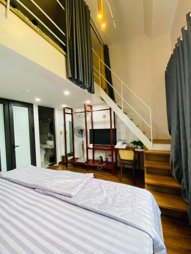 a bedroom with a large bed and a staircase at Hồng Vân Homestay in Cao Bằng
