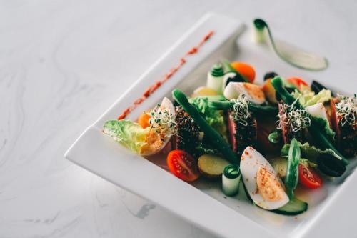 a plate of food with vegetables on a table at Awesome Hotel in San Juan