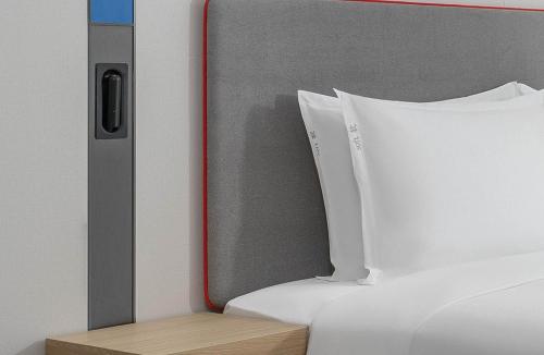 a close up of a bed with a white pillow at Holiday Inn Express Xi'an Daxing by IHG in Xi'an