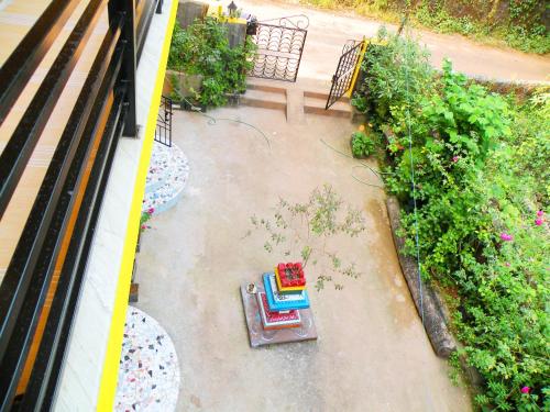 an overhead view of a garden with a bench and flowers at Sai Guru Guest House in Anjuna